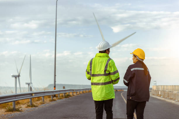 istock Rear View Of Engineer Examining Windmill 1412916164