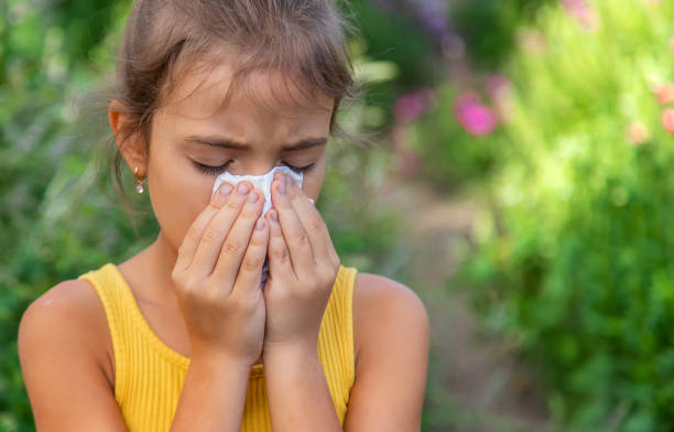 istock Girl Sneezing With Tissue On Mouth 1412917346