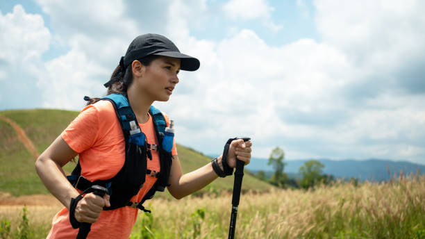 istock Young Woman Walking On Grassy Land 1412918140