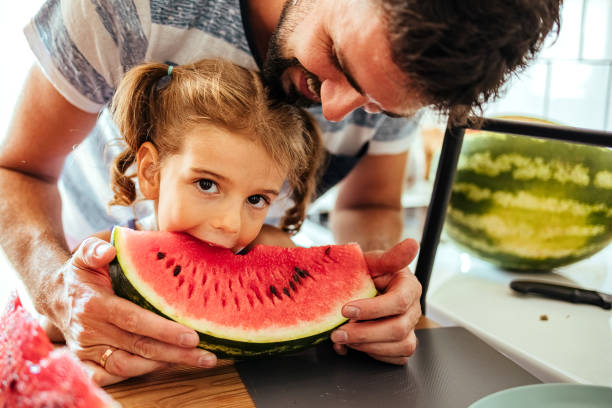 istock Girl is eating a watermelon 1412919337