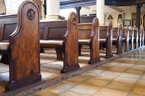 Wooden benches in a cathedral church in England. Also known as pew or seats.