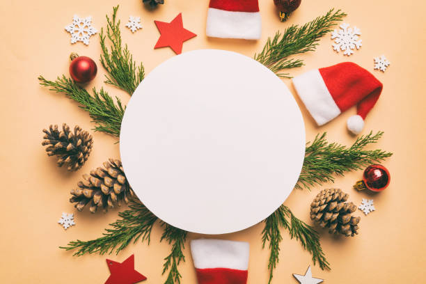 istock Flat lay Christmas composition. Round Paper blank, pine tree branches, christmas decorations on Colored background. Top view, copy space for text 1412926042