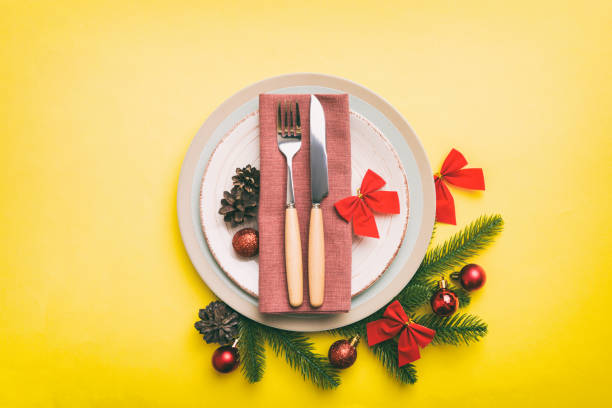 istock Christmas table place setting with christmas decor and plates, kine, fork and spoon. Christmas holiday background. Top view with copy space 1412926698