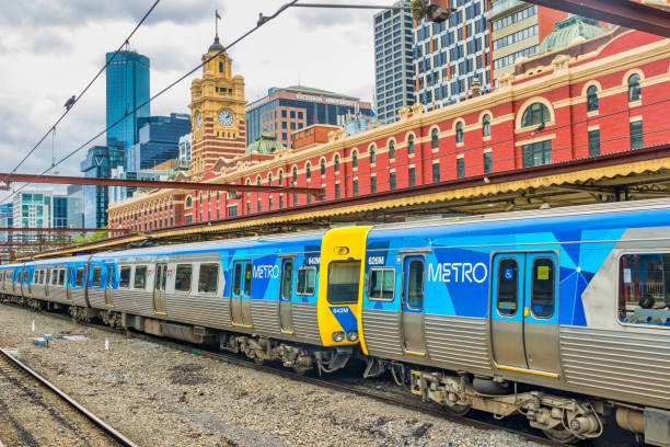 Metro train stands at Flinders Street Railway Station in downtown Melbourne, Victoria, Australia on an overcast day.