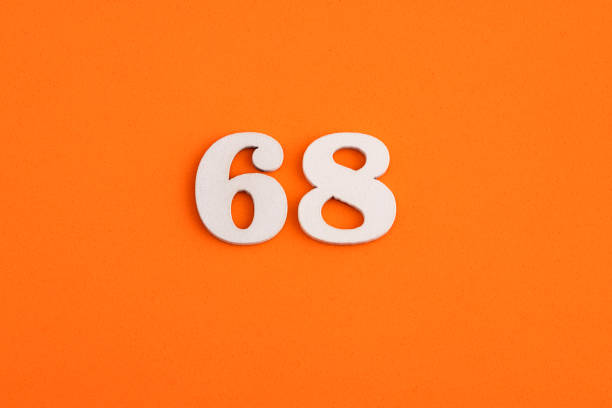 White wooden number 68 on eva rubber orange background