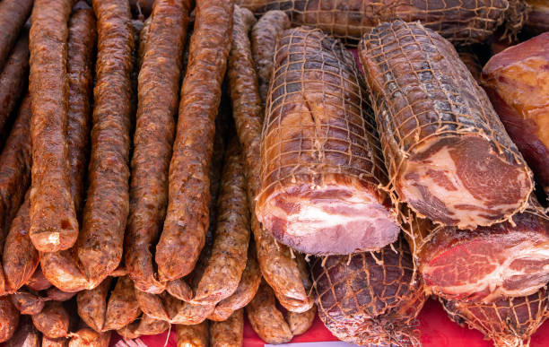 istock Smoked bacon and sausages on market stall 1412930114