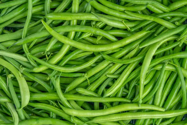 Photo of Fresh green bean pods texture. Close up, top view