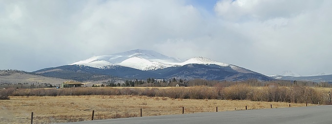 Western plains and a distant view of a large snow covered mountain range