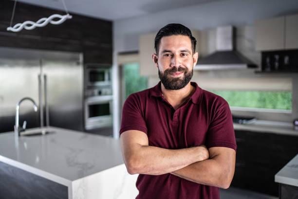Portrait of mid adult man in the kitchen at home stock photo