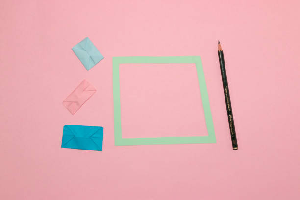 istock frame next to letters and pen, pink background, creative art modern design, minimal concept, copy space 1412933199