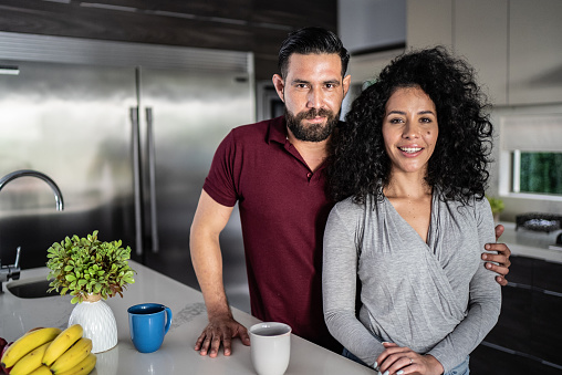 Portrait of mid adult couple in the kitchen at home