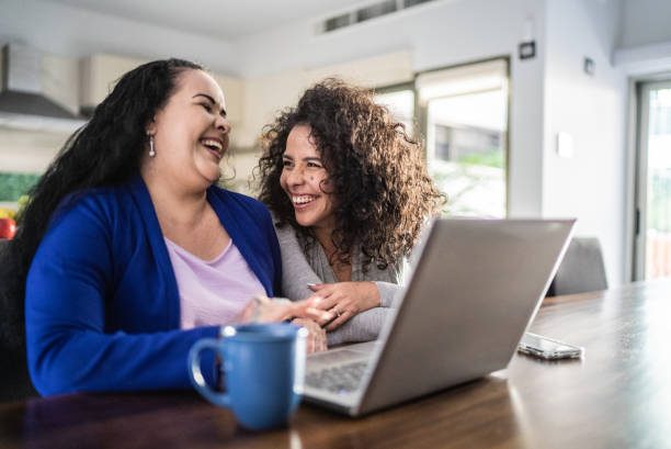 istock Friends using laptop at home 1412934144
