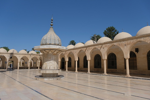 Sanliurfa, Turkiye - July 12, 2022: Inside the ancient mosque yard in Sanliurfa, Turkey. Mosque made of limestone.