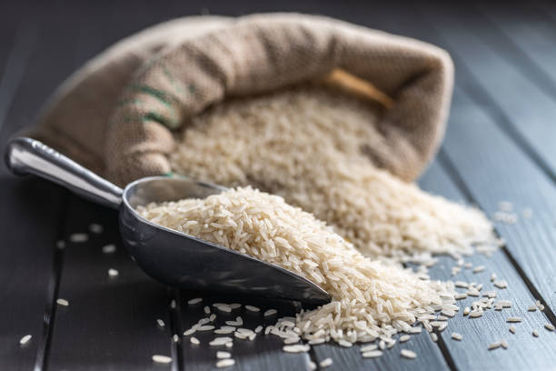 istock Uncooked white rice in metal scoop. 1412939203