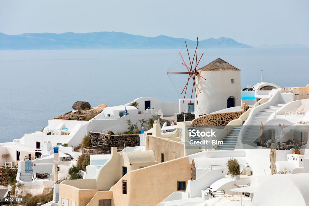 Village of Oia in Santorini, Cyclades Islands, Greece Village of Oia in Santorini with windmill, Cyclades Islands, Greece. Europe Stock Photo