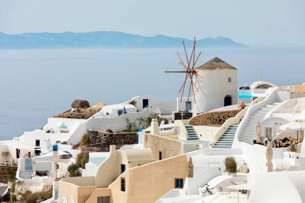 Village of Oia in Santorini, Cyclades Islands, Greece Village of Oia in Santorini with windmill, Cyclades Islands, Greece. santorin stock pictures, royalty-free photos & images