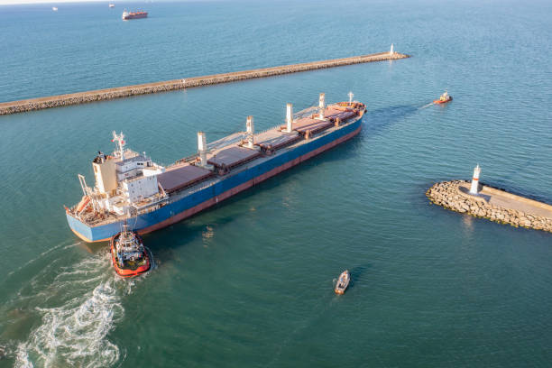 istock Tugboat towing a large cargo ship on sea. 1412948323