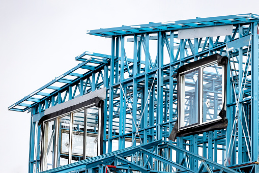 Construction site of house steel frame, closeup, background with copy space, full frame horizontal composition