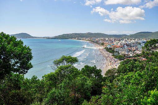 Beautiful view from the top of a hill of Bombas and Bombinhas beach, Santa Catarina state, Brazil. Crowded beach in a summer day. Atlantic Forest