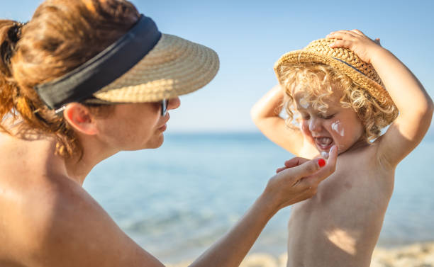 istock Mother applying sunscreen protection cream on little boy 1412951301