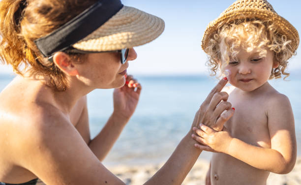 istock Mother applying sunscreen protection cream on little boy 1412951370