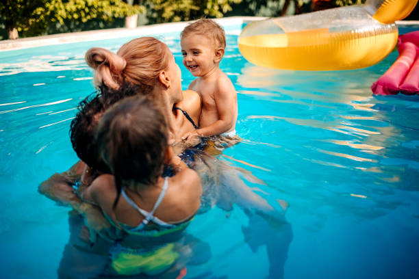 istock Happy family at the pool 1412951832