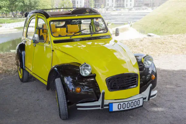 Photo of Typical French yellow small retro car in city festival