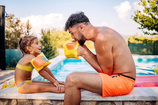 Father and daughter at the pool