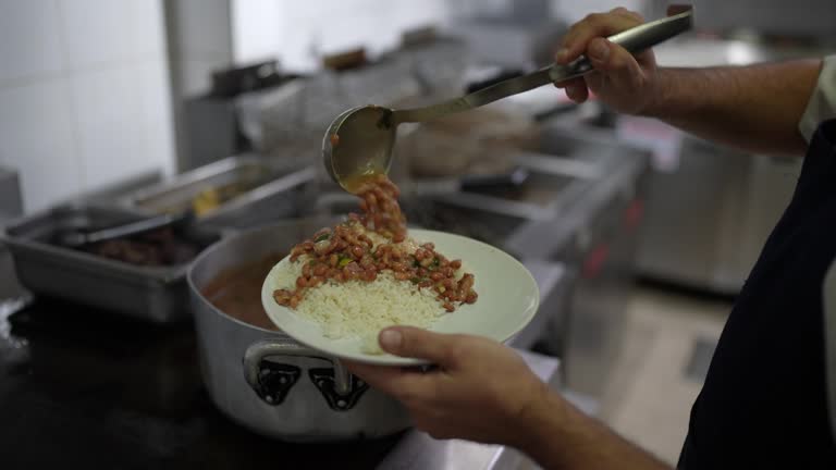 Chef serving rice and beans