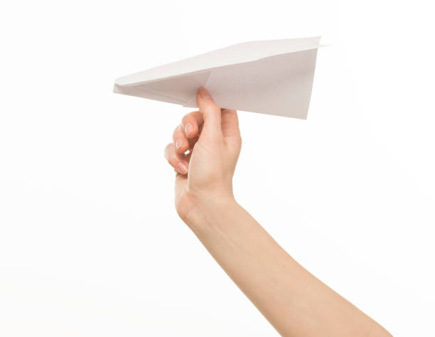 istock hand holding a paper airplane on a white background isolated 1412956518
