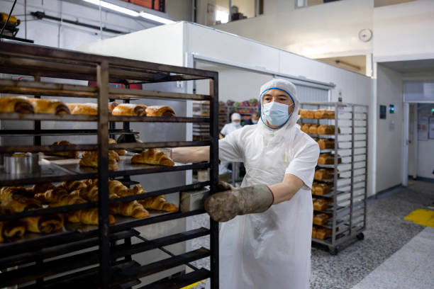 istock Man working at an industrial bakery 1412956713