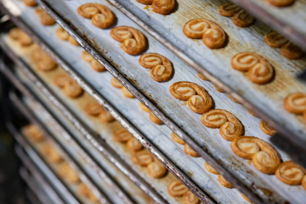 Freshly baked heart shaped pastries coming out of the over at a bakery