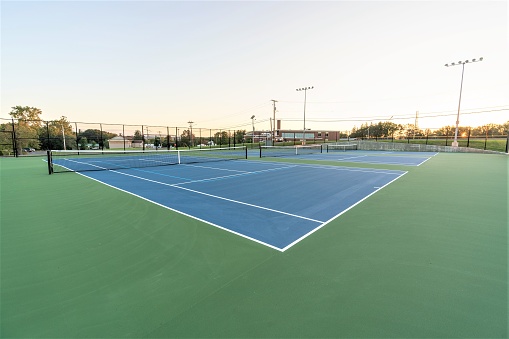 Close up photo of blue tennis court with pickleball lines.