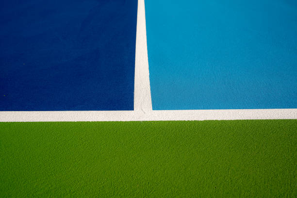 istock Example image of a newly surfaced, empty pickleball court with multi-color surface and white lines. 1412958602