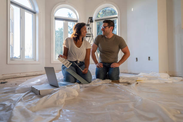 istock Young Couple Picking Out Paint Colors 1412959927