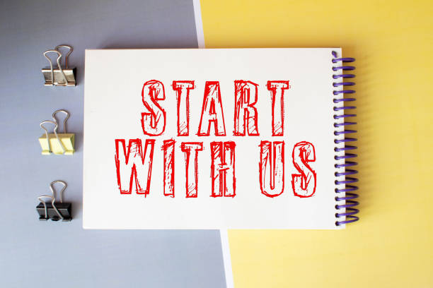 istock The text Let us get started with red notebook aside isolated on a white paper background. 1412964522