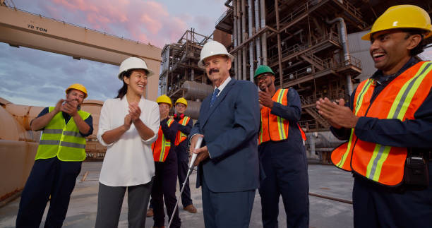 istock Managers and Workers Clapping Hands at Ribbon Cutting Event at Power Plant 1412964792