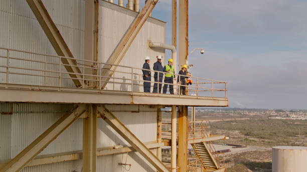 istock Power Plant Worker Standing on External Catwalk - Aerial 1412965377