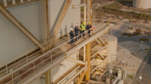 istock Power Plant Worker Standing on External Catwalk - Aerial Shot 1412965382