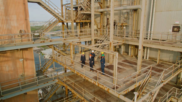 istock Drone Shot of Workers on Walkway Looking Into Distance 1412965390