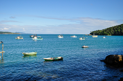 View of boats at Lagoinha Beach in a beautiful sunny day, in Bombinhas, Santa Catarina, Brazil