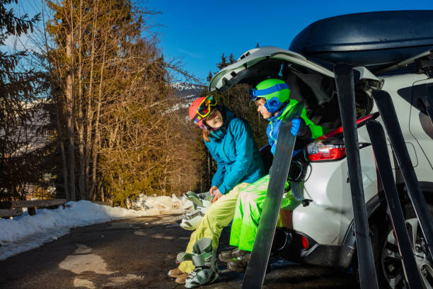 istock Mother with son put on boots to go ski and snowboard 1412972663