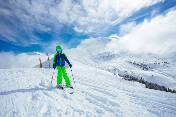 istock Preteen handsome boy ski downhill on mountain slope 1412972717