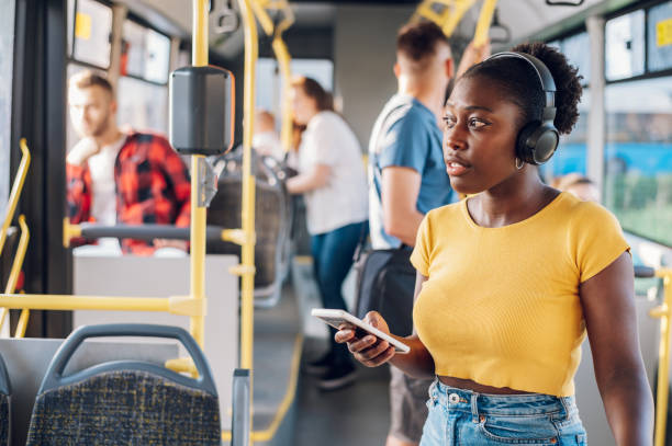 istock African american woman using smartphone while riding a bus 1412974569