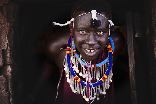 Portrait of Maasai mara man with traditional colorful necklace at Maasai Mara tribe village, Safari travel destination near Maasai Mara National Reserve, Kenya