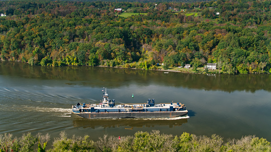 Aerial shot of a barge on the Hudson River near Stuyvesant, New York on a clear autumn day.