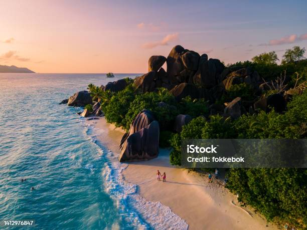Anse Source Dargent La Digue Seychelles Young Couple Men And Woman On A Tropical Beach During A Luxury Vacation In The Seychelles Tropical Beach Anse Source Dargent La Digue Seychelles Stock Photo - Download Image Now