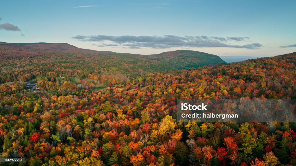 Aerial Shot of Fall Colors in Upstate New York Aerial shot of Haines Falls, New York and surrounding woodlands in autumn at sunset. Haines Falls is a small town in the Catskill Mountains. Autumn Stock Photo