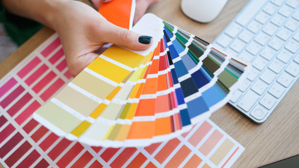 istock Interior designer holding fan of colourful samples in hand 1412977499