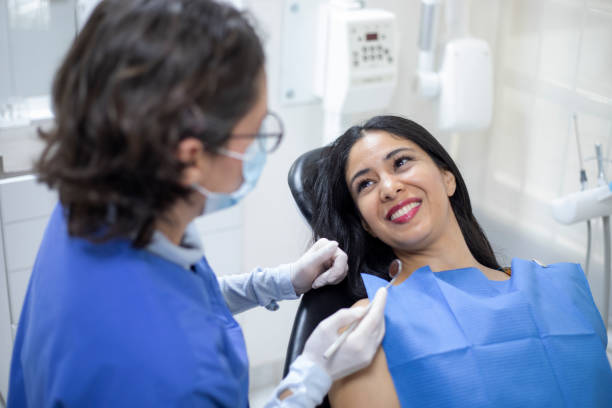 istock dentist with patient in the office 1412979743